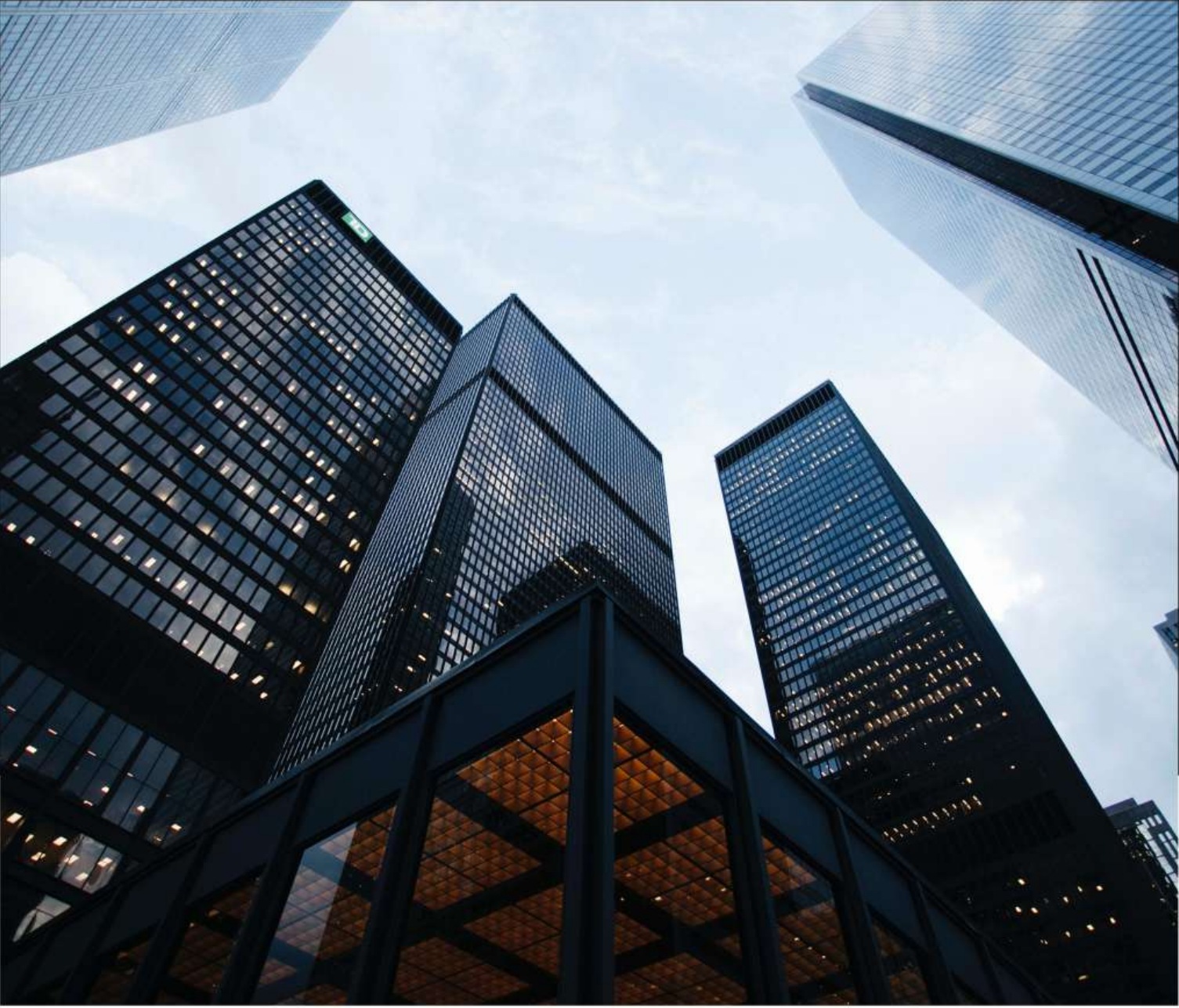 A dramatic upward view of contemporary glass architecture